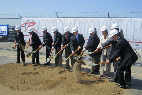 Local officials and leaders gather for the groundbreaking ceremony of Rectrix Aviation's new fixed-based operations facility in Massachusetts.
