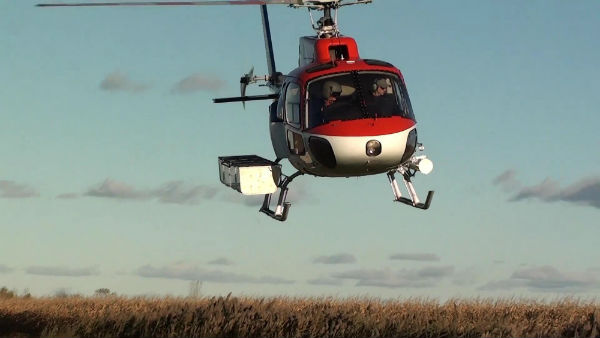 Airbus Helicopters AS350 fitted with a DART heli-utility basket