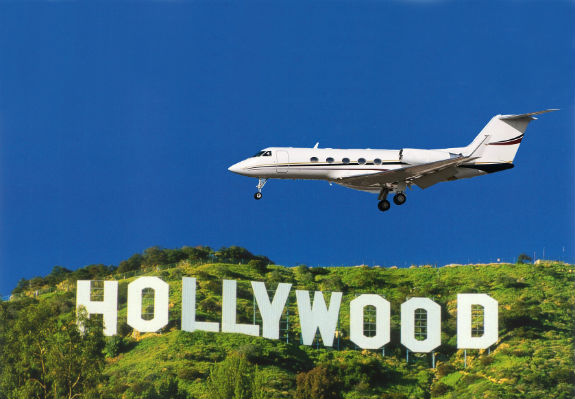 Gulfstream business jet flying over the Hollywood sign